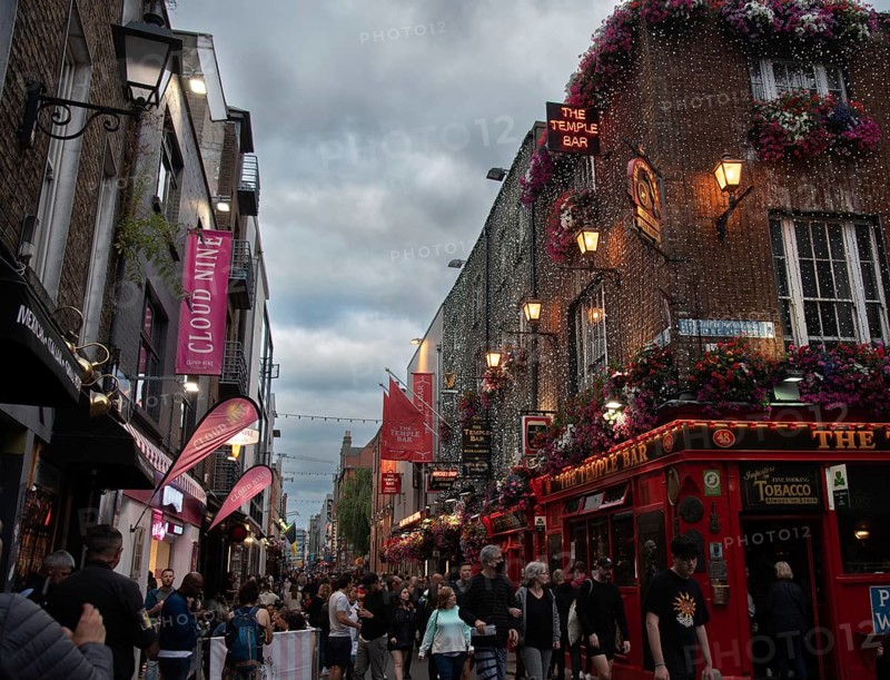 Ireland, Dublin, June 20 2022: People outside the famous Irish pub The Temple Bar in the centre of the Irish capital, men women tourists citizens walking, Europe
