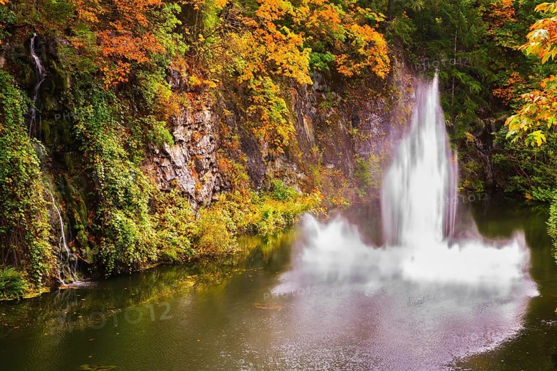 Dancing fountain in a quiet pond. Autumn day in the park. Butchart Gardens on Vancouver Island, Canada, North America