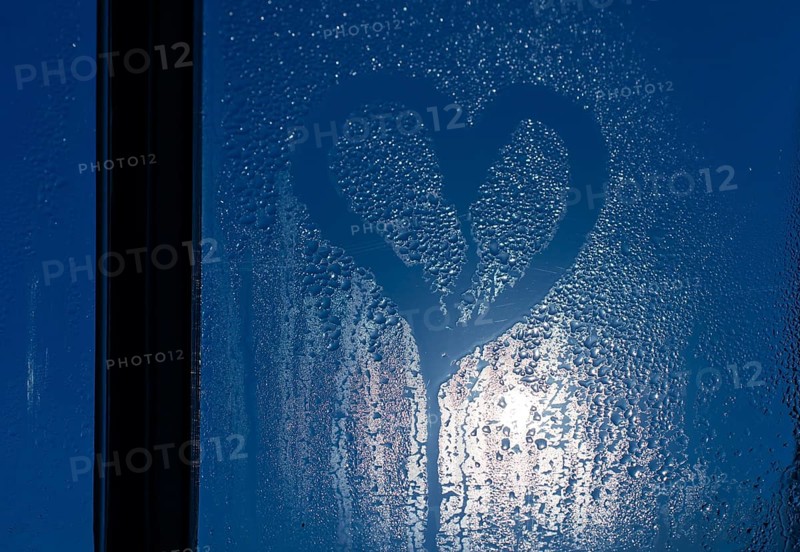 Moonlight through the window. Sweaty glass and heart shape