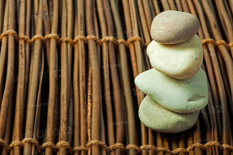 Stacked stones on wooden base. Studio shot