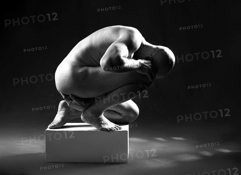 Studio portrait of athletic man. Body sculpture. Monochrome photo