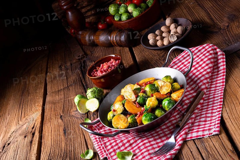 Brussels sprouts potato pan with bacon in a rustic style