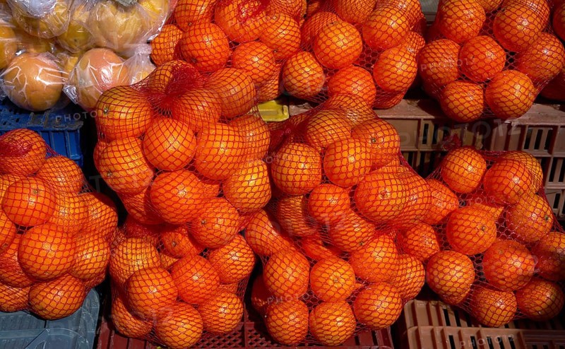 Oranges from Mediterranean in net bags at the outdoor market