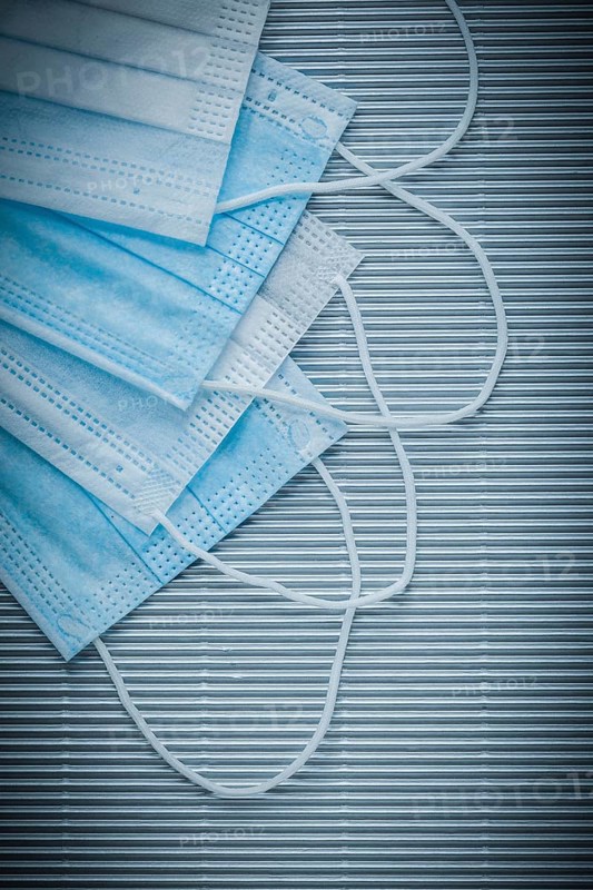 Set of medical disposable face masks on striped background