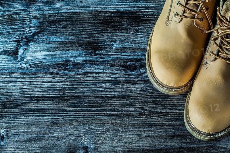Safety boots on vintage wooden board