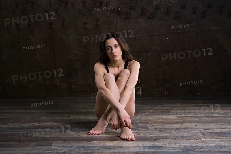 Abstract and stress emotional concept. depressed girl in lonely mood, theme of stressful. Sad woman sitting alone in empty room. Depression and chronic fatigue. female having psychological trauma