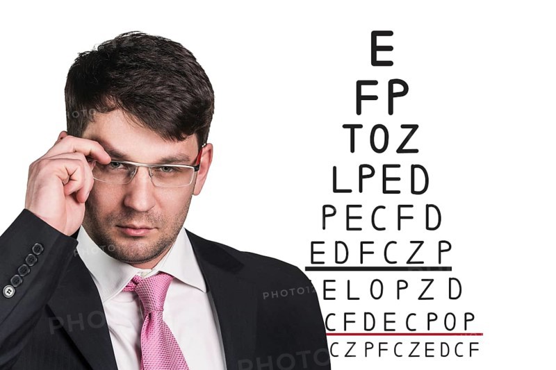 Man with glasses on eyesight test isolated on white background