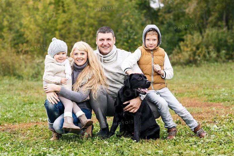 Happy family with dog on nature