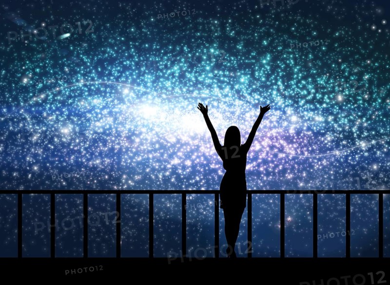 Silhouette of young happy woman stands on the bridge in cosmos