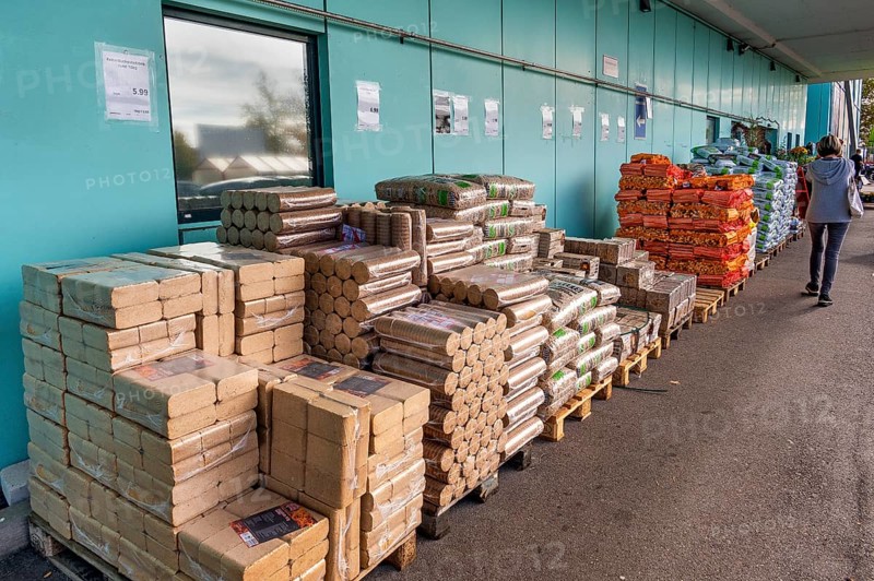 Plastic bags with wood pellets, wood briquettes and firewood at a wholesale market, Allgäu, Bavaria, Germany, Europe