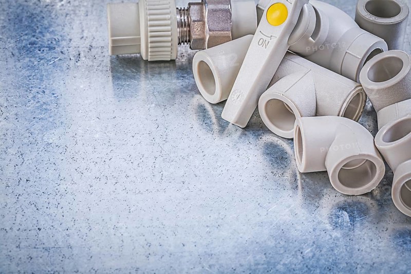 Water valve threaded pipe connectors on metallic background construction concept