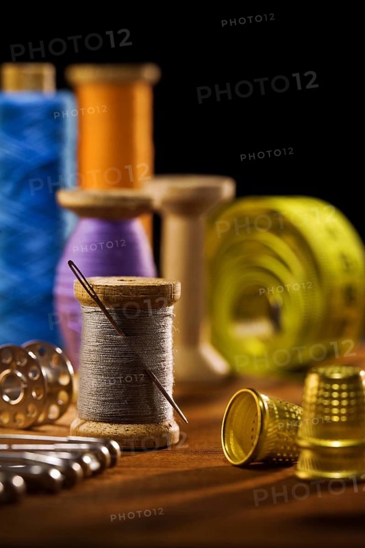 Sewing items on brown wooden bards