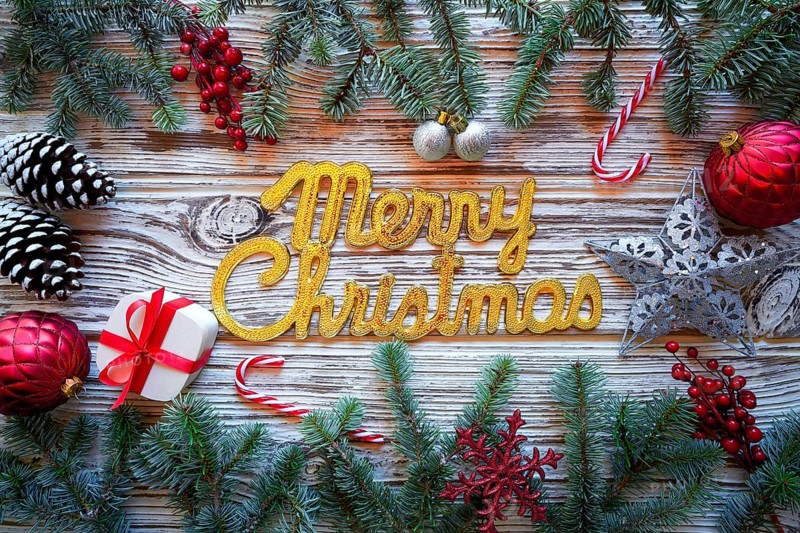 Merry Christmas spell word on white wood background