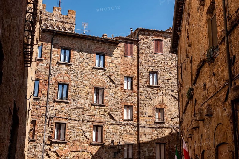 Facade of beautiful residential houses in the center of Volterra, Italy, Europe