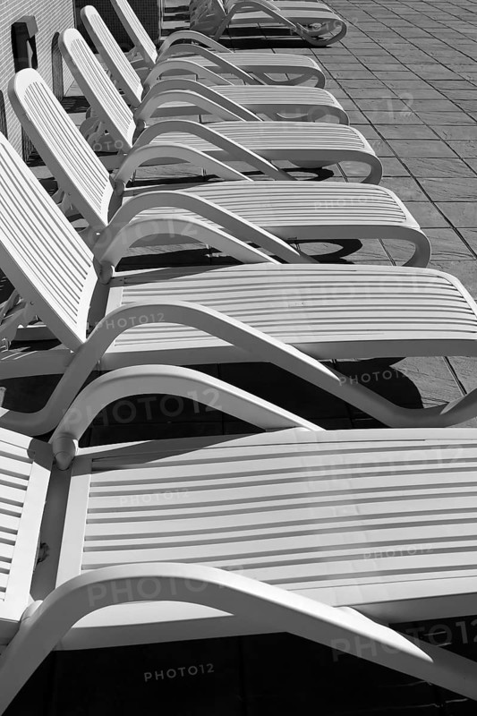 White resin solarium hammocks row black and white