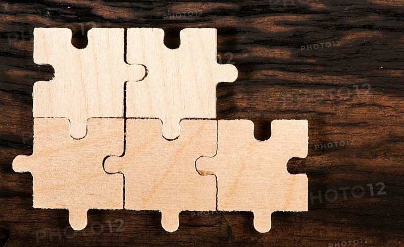 Wooden puzzle on dark wooden background