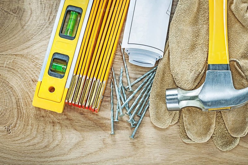 Blueprints construction level safety gloves wooden meter claw hammer nails building concept