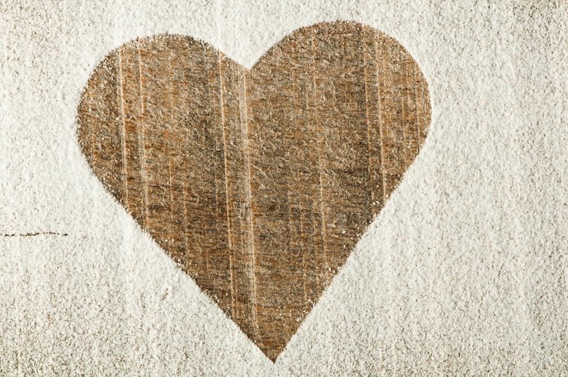 Heart pattern on an old wooden board. Heart made of sugar