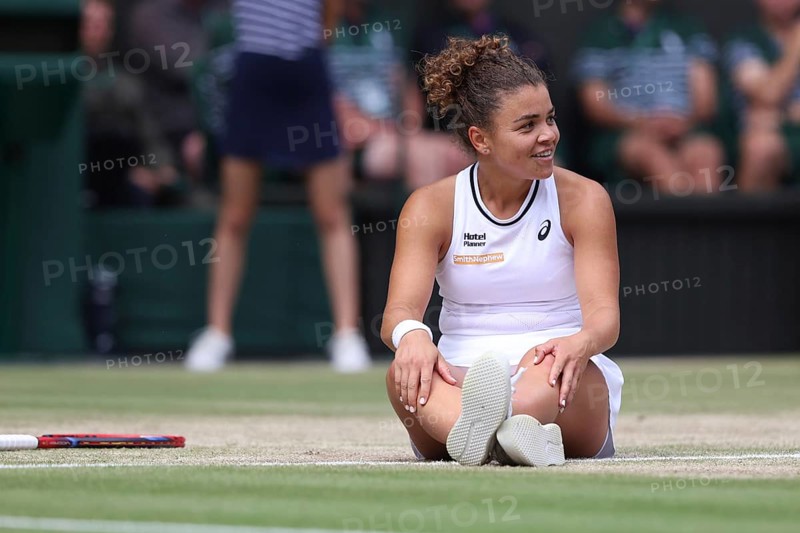 Italian tennis player Jasmine Paolini sitting on the ground after a fall at the 2024 Wimbledon Championships, London, England, United Kingdom, Europe