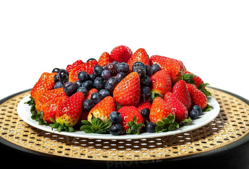 Three kinds of fresh berries on a white plate, on white background