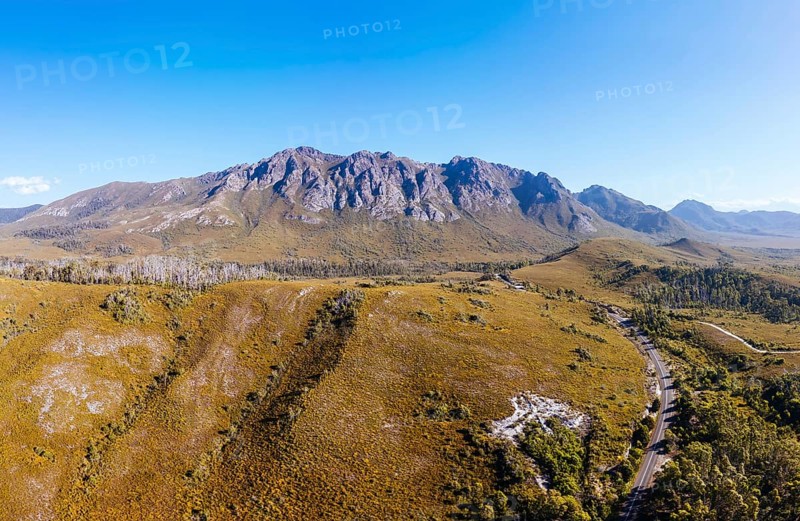 An aerial view of Gordon River Rd at the Sentinel range of mountains near Bitumen Bones Sculpture on a hot summer's afternoon in Southwest National Park, Tasmania, Australia, Oceania