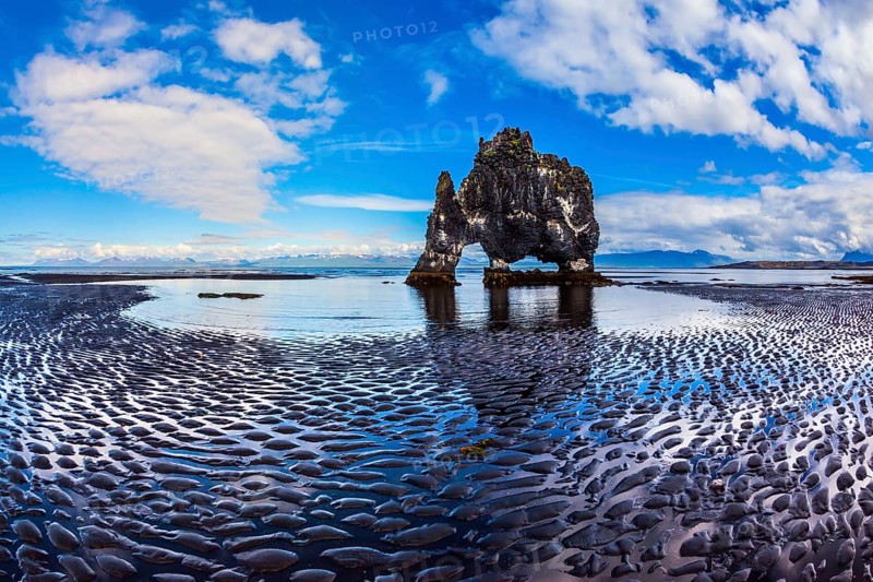 The north coast of Iceland. Ocean tide at sunset. Rock Hvitserkur on the sea beach in the form of a huge elephant. The concept of extreme northern tourism