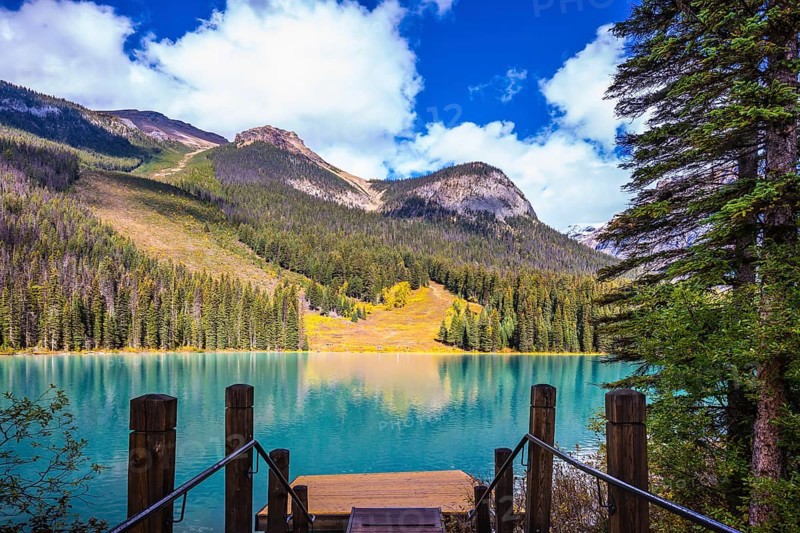 Magic Emerald Lake in Yoho National Park, Rocky Mountains. The descent to the water on the lake promenade. The concept of eco-tourism