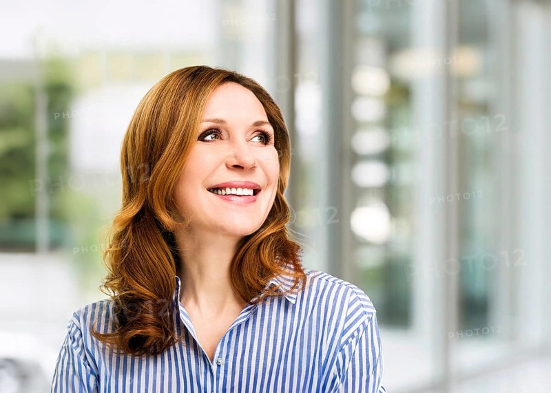 Smiling confident stylish mature middle aged woman at office. Senior businesswoman, executive business leader manager looking at camera arms crossed, portrait