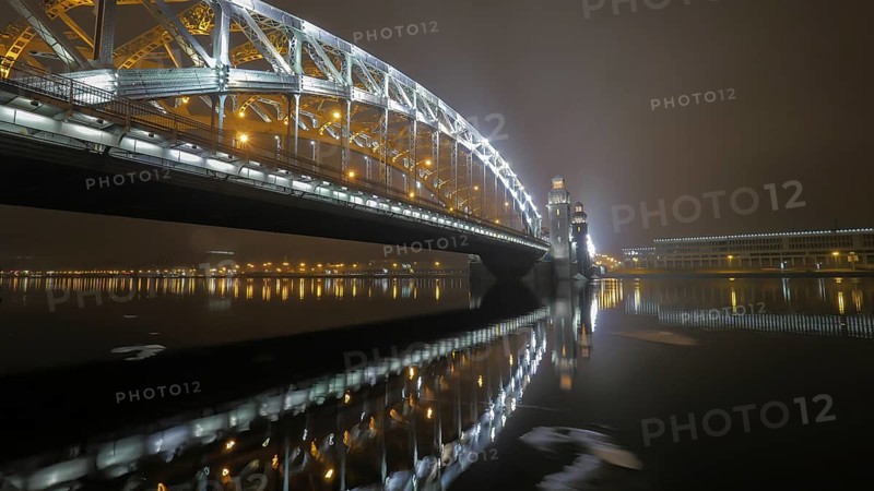 Illuminated Peter the Great Bridge across Neva River in night Saint Petersburg, Russia, Europe