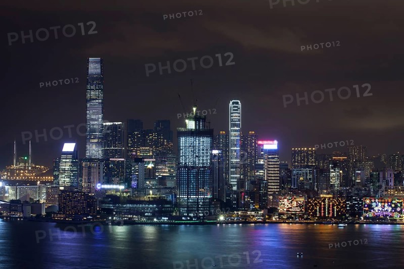 Symphony of Lights in night Hong Kong. Illuminated skyscrapers and colorful reflection in water from city lights