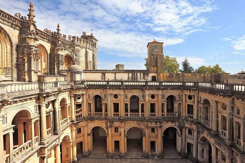 Courtyard, patio, surrounded by a gallery. The imposing medieval castle of the Knights Templar and the bell tower