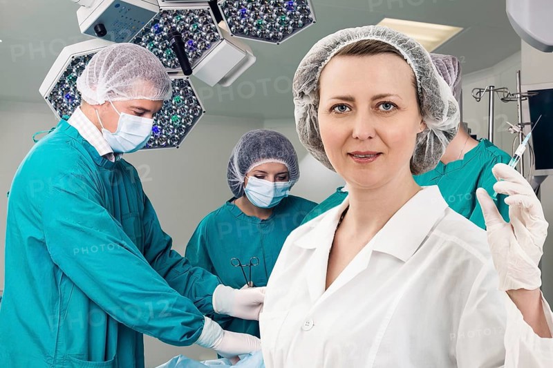 Adult female anesthetist with syringe on the surgery teem background