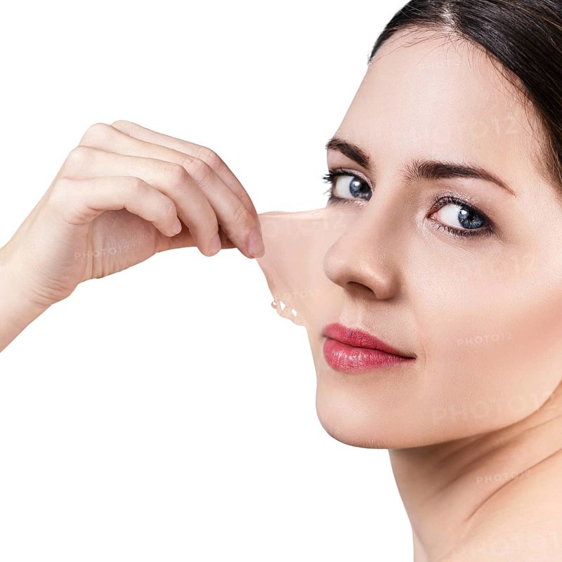 Beautiful woman remove her old dry skin from face. Over gray background