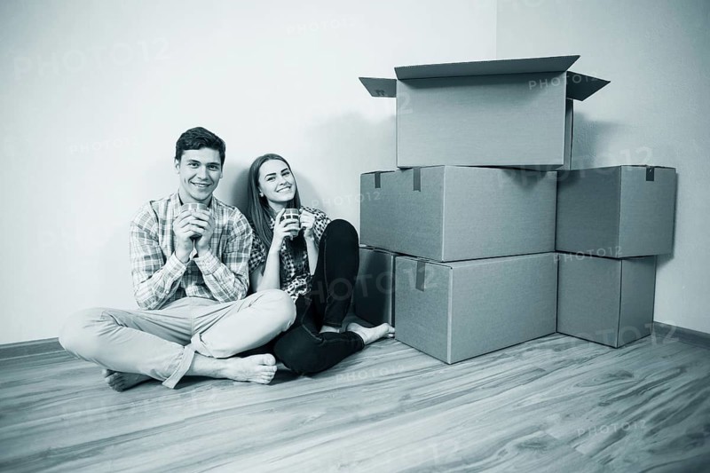 Relocated couple drinking tea on the floor