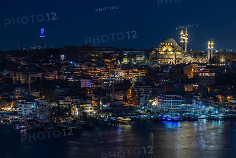 A picture of the Suleymaniye Mosque and the Golden Horn waterfront at night
