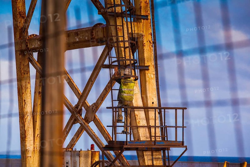Worker climbing on a crane