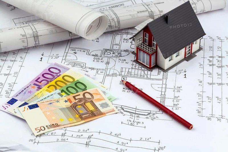 An architect's construction plan with euro money. Symbolic photo for financing and planning a new house
