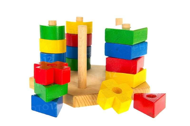 Colorful wooden baby toys isolated over white