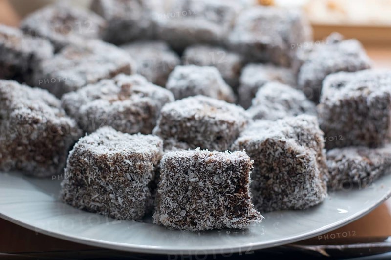 Close up of chocolate cakes with coconut flour on the ceramic plate