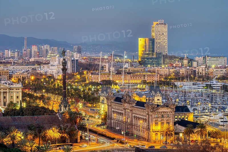 The Barcelona skyline with the Columbus statue at dusk