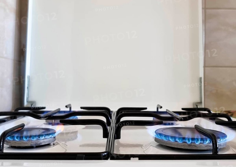 Energy efficiency concept with gas cooker – the cost of natural gas is more expensive. Close up, selective focus