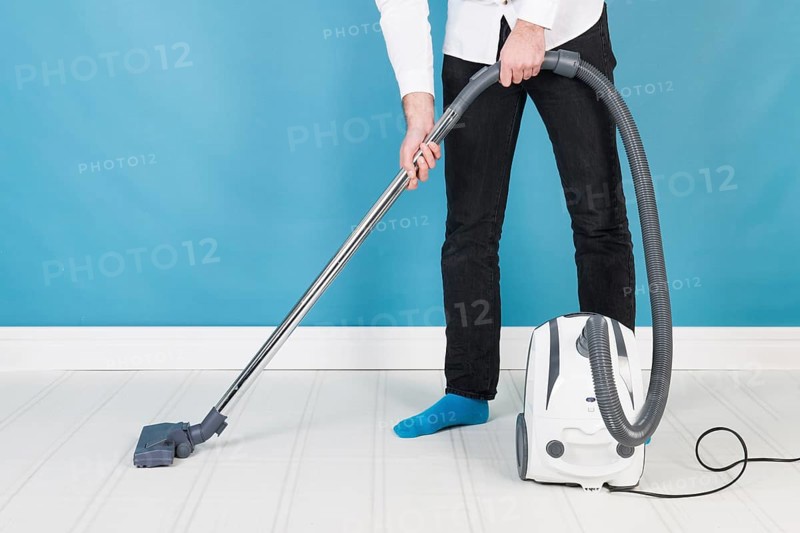 Man with vacuum cleaner cleaning the interior