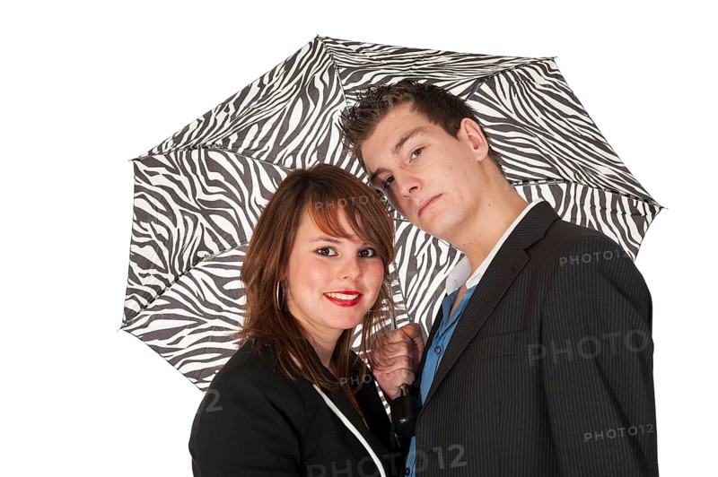 Young couple under black and white zebra umbrella