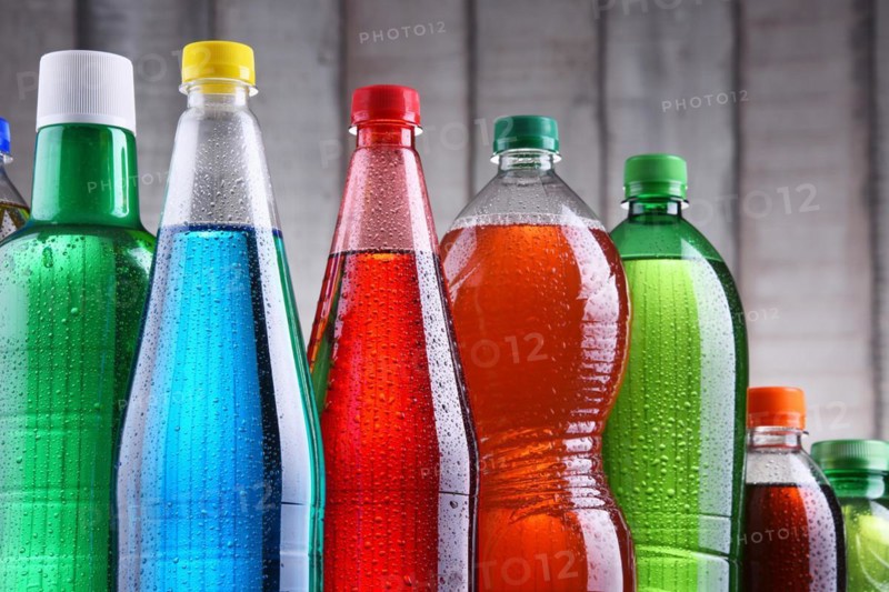 Plastic bottles of assorted carbonated soft drinks in variety of colors