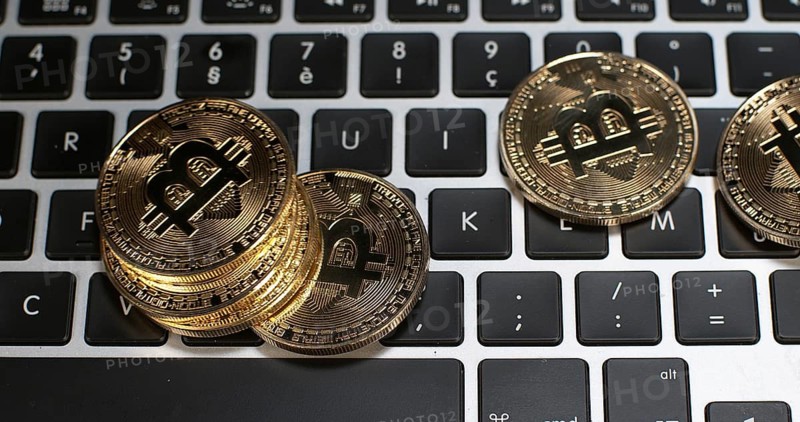 Bitcoins on Computer Keyboard Background