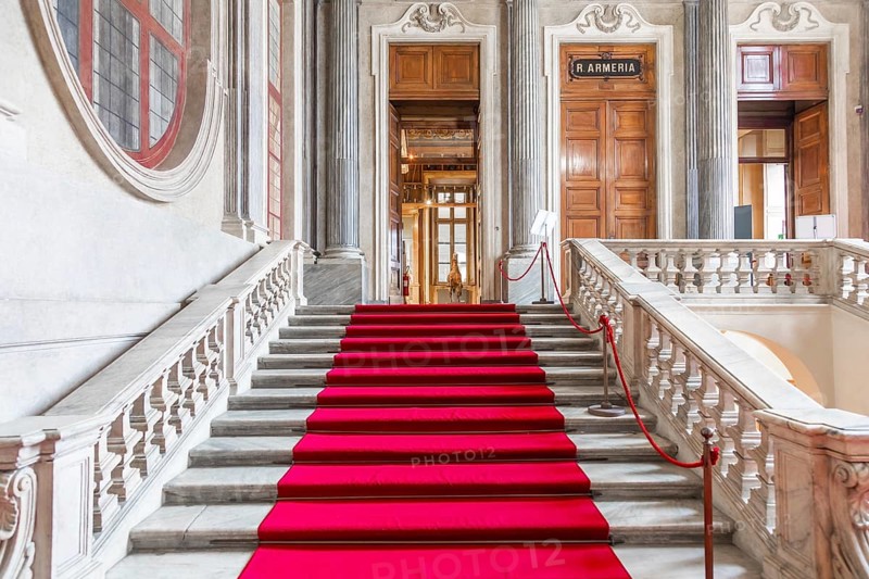 Turin, Italy - Circa January 2022: red carpet in Royal Palace - luxury elegant marble stairway