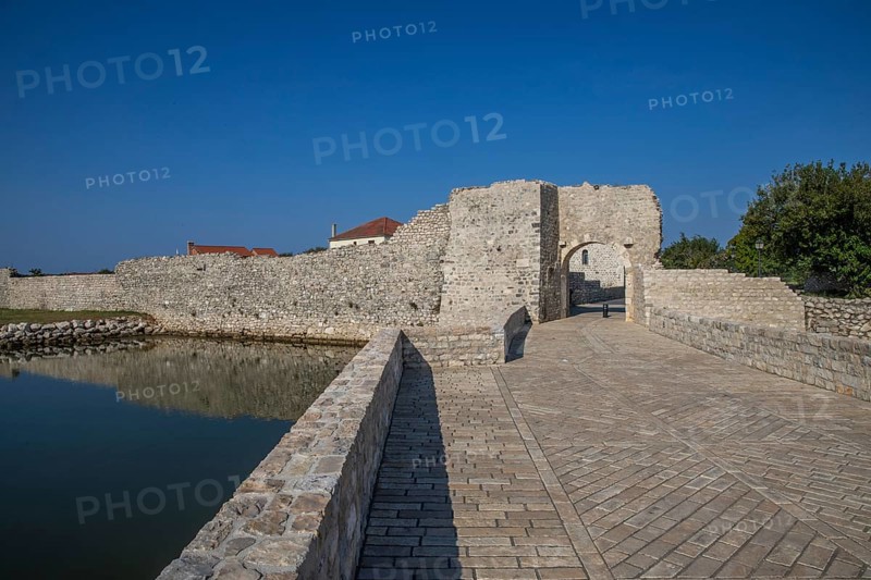 Skyline of a small Mediterranean town, historic city centre with massive city walls on an island in a bay or lagoon. Morning atmosphere in Nin, Zadar, Dalmatia, Croatia, Adriatic Sea, Europe