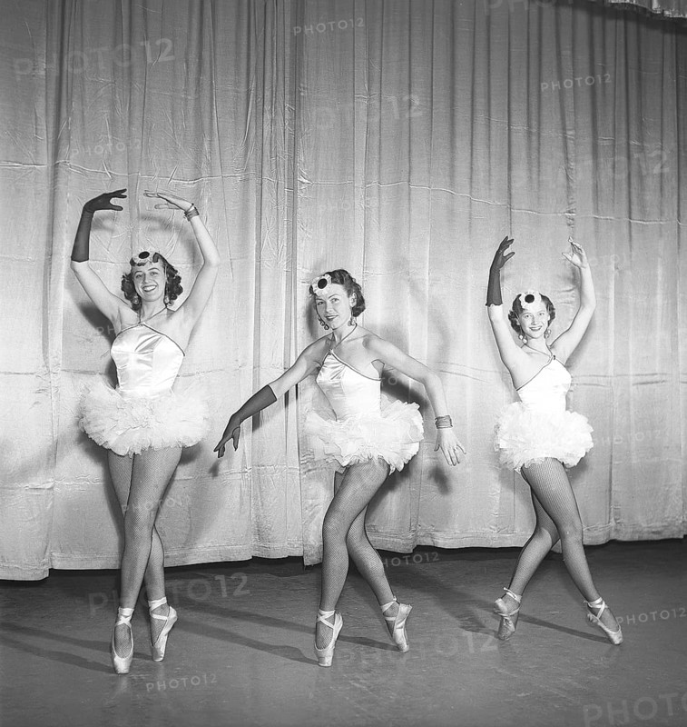 Ballerinas in the 1950s. Three young ballerinas all dressed up in their costume and shoes posing on a theatre stage in different positions. Photo Kristoffersson Ref BH41-12. Sweden 1953