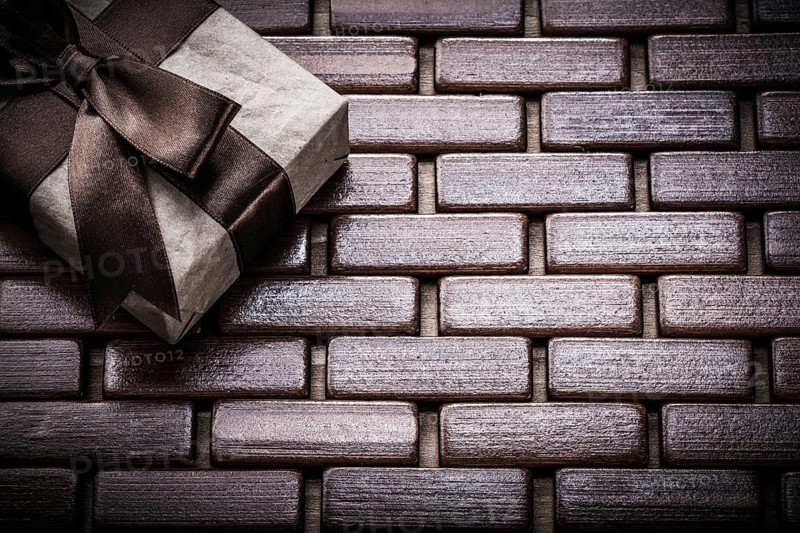 Packed giftbox on wooden wicker matting holidays concept