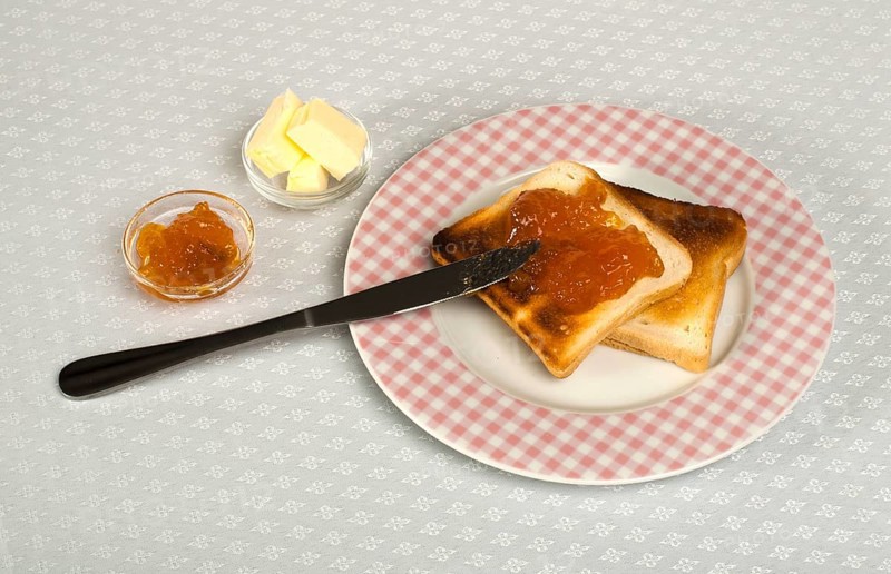 Spread jam on bread with knife